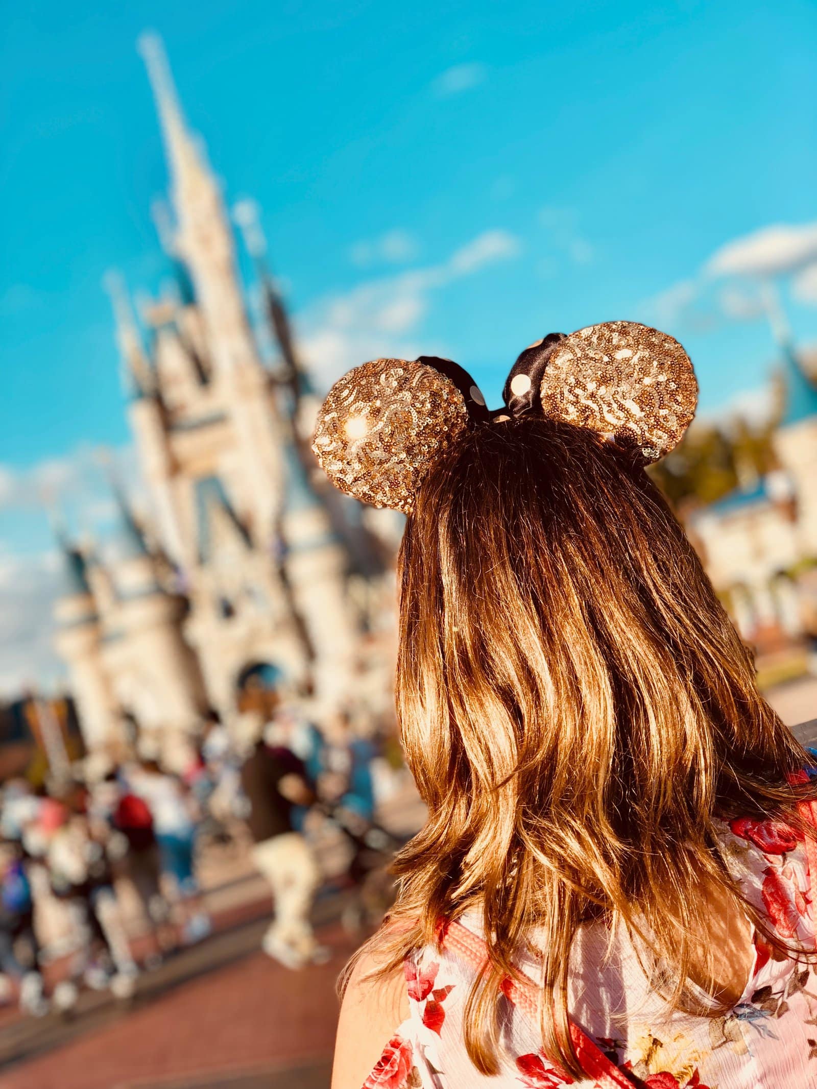 woman at disney world wearing mickey ears