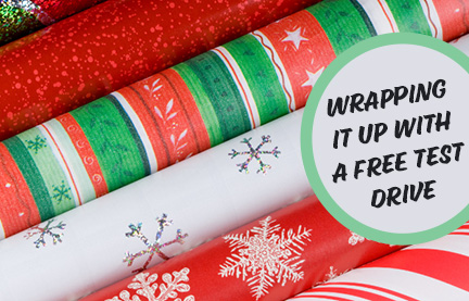 an image of 5 rolls of xmas wrapping paper with a message on them that reads: wrapping it up with a free test drive.