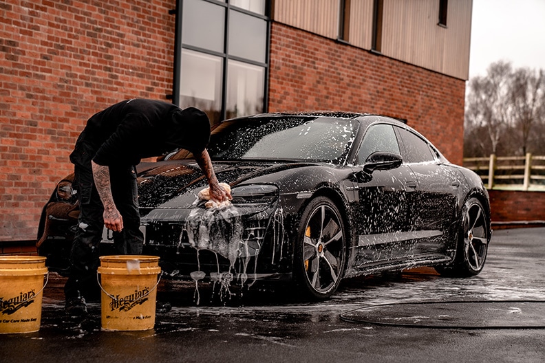 young man hand washing car