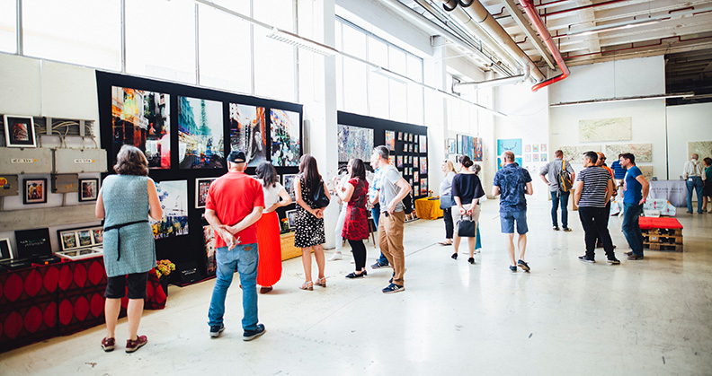 air faie people looking at art in large hall