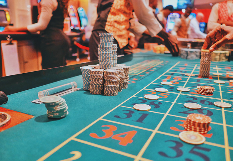 people throwing dice on game table