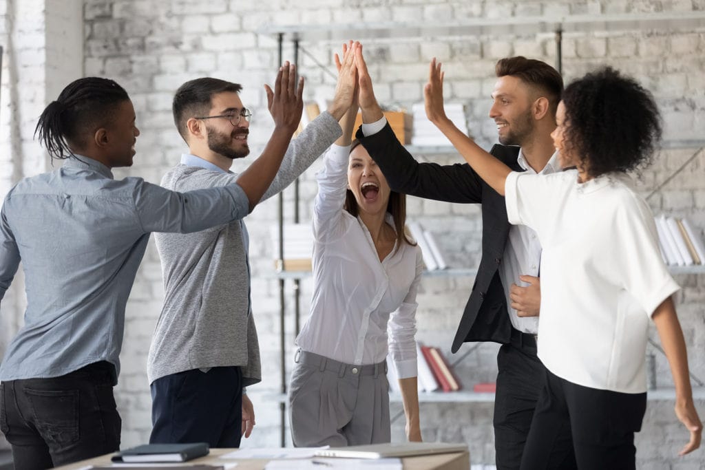 five employees highfiving