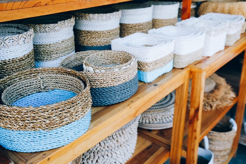 different handmade weaving baskets in craft shop in a row.