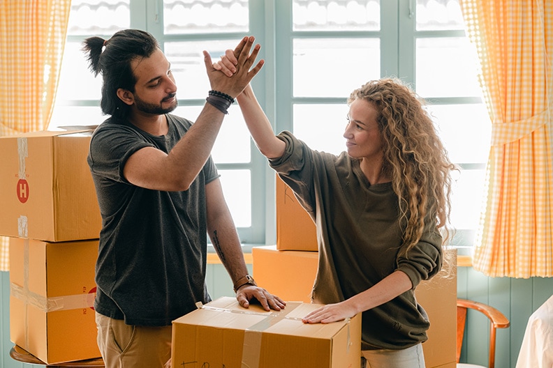 twenty somethings man and woman packing home up to move