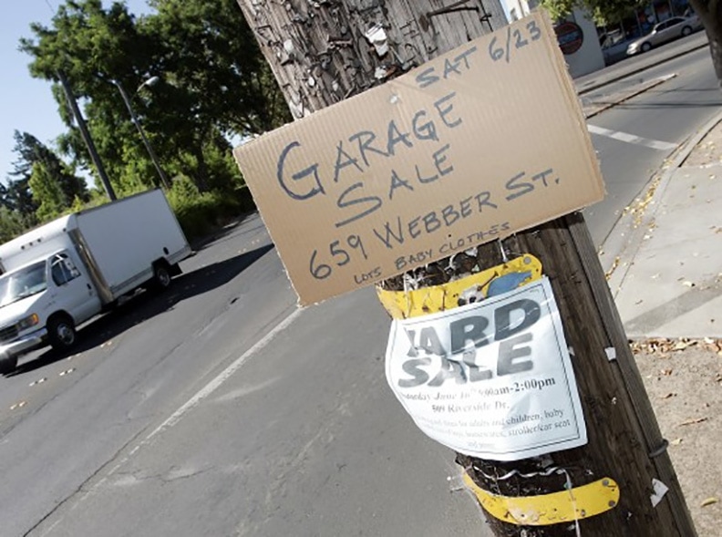 handmade garage sale sign on pole