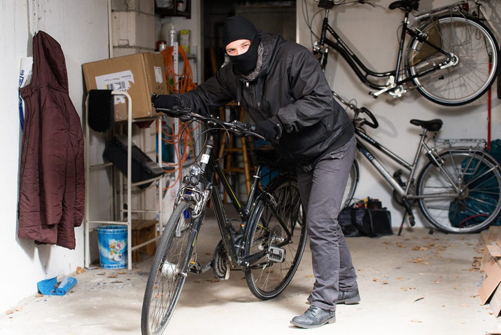 man stealingn a bike from garage