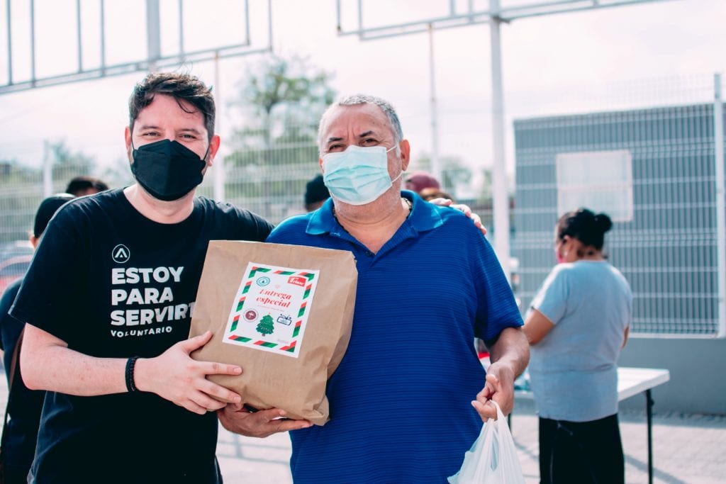 volunteer and man with gift bag