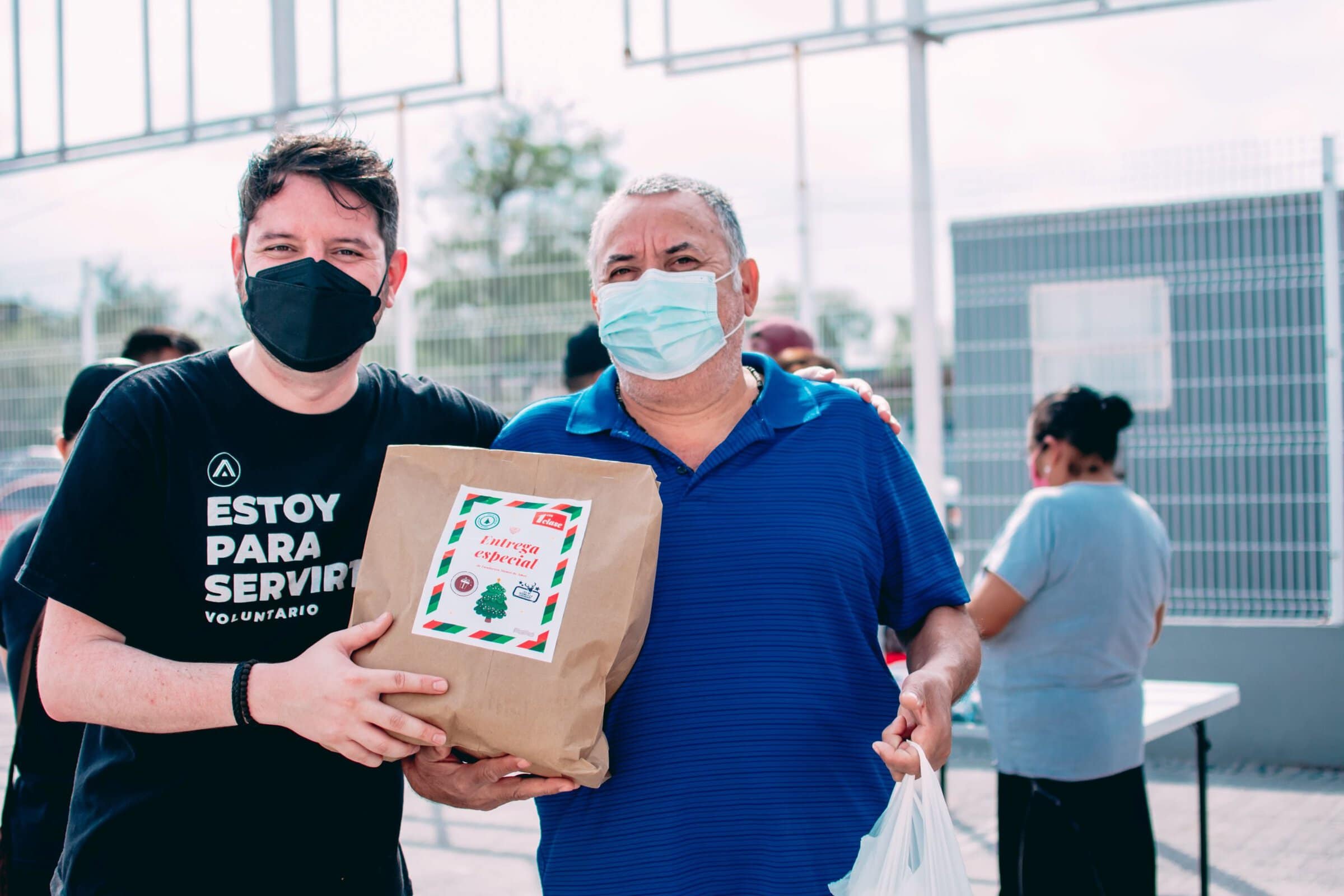 volunteer and man with gift bag