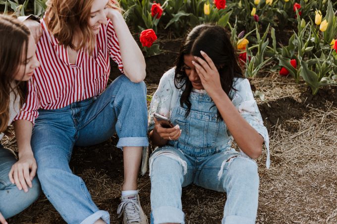 young women with a phone and flowers