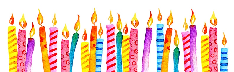 a row of multicolored candles birthday lit