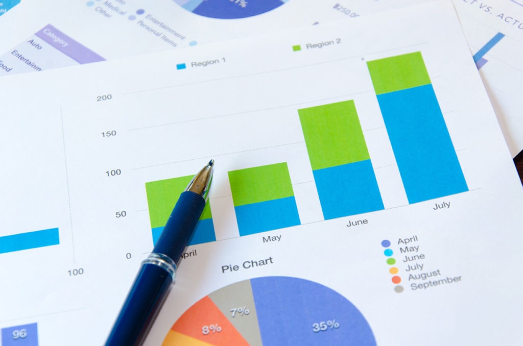 graphs and charts on paper indicating KPIs or key performance indicators