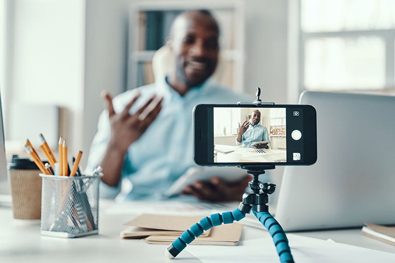 smart phone videoing man speaking as he makes a fundraising video.