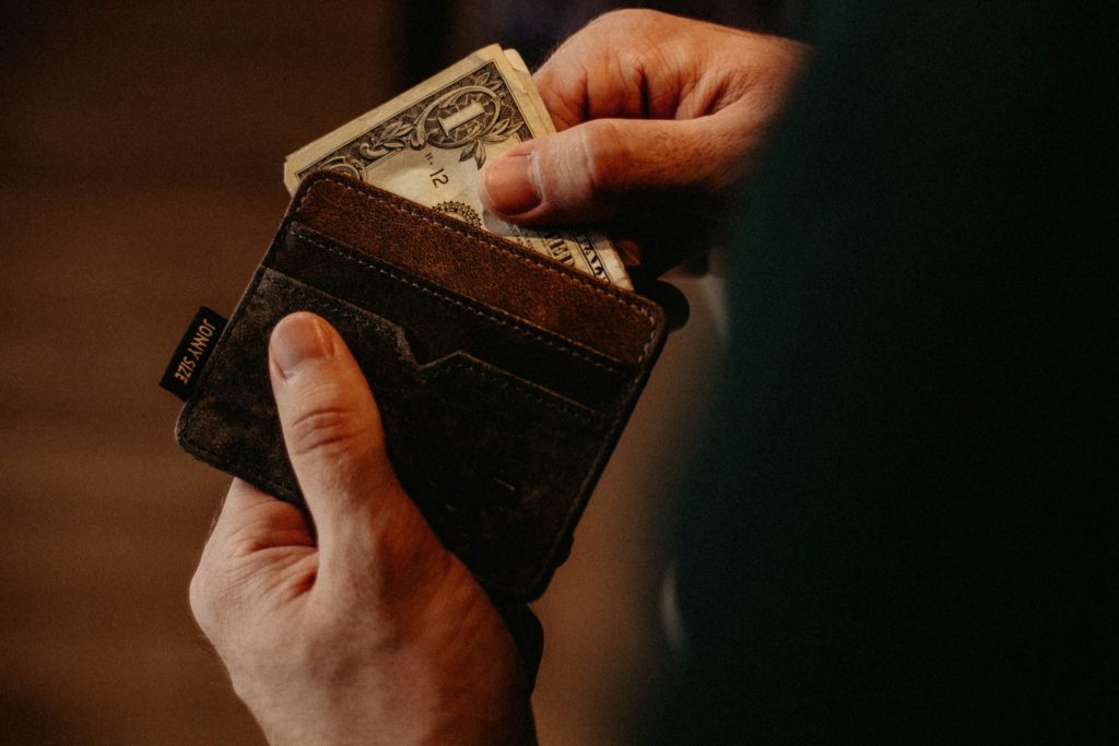 hands taking bills out of wallet