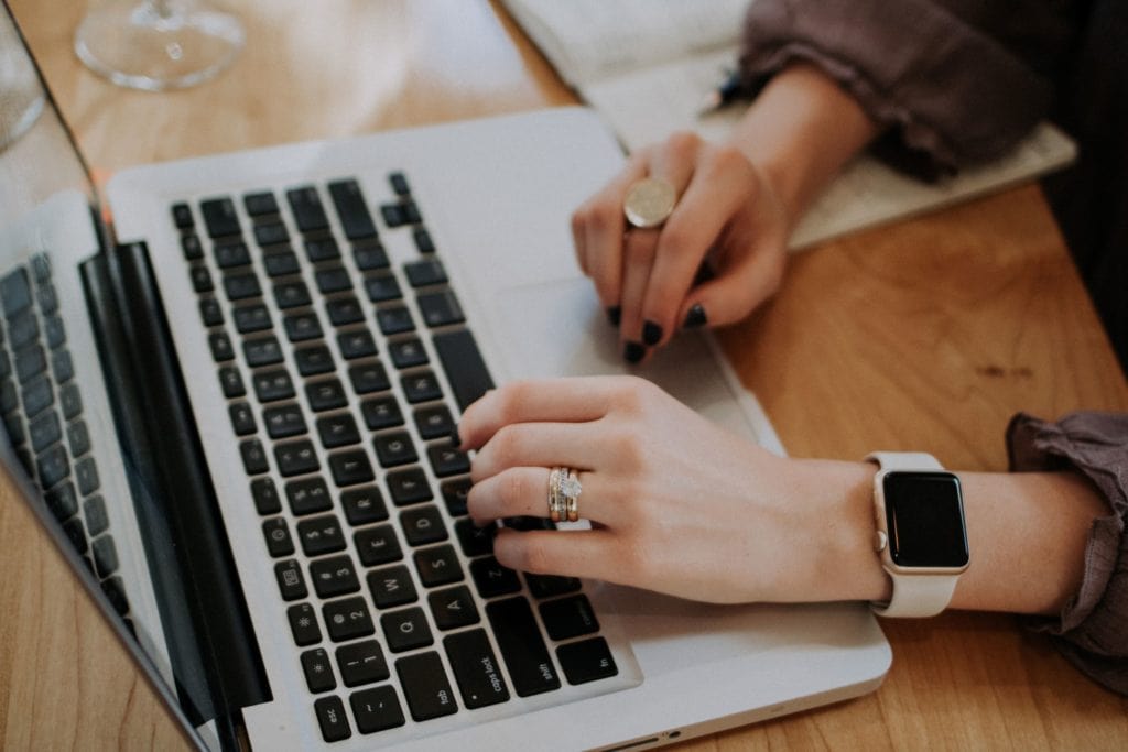 woman's hands on laptop