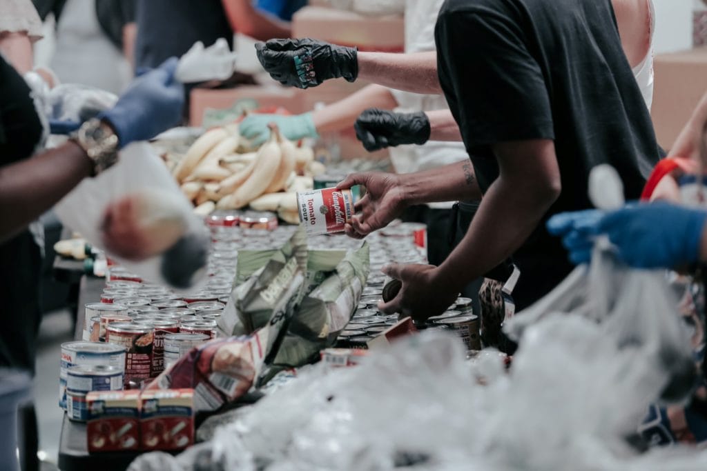 people sorting canned goods at a food drive