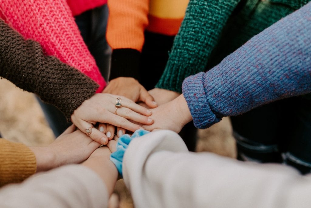 women's hands in a circle