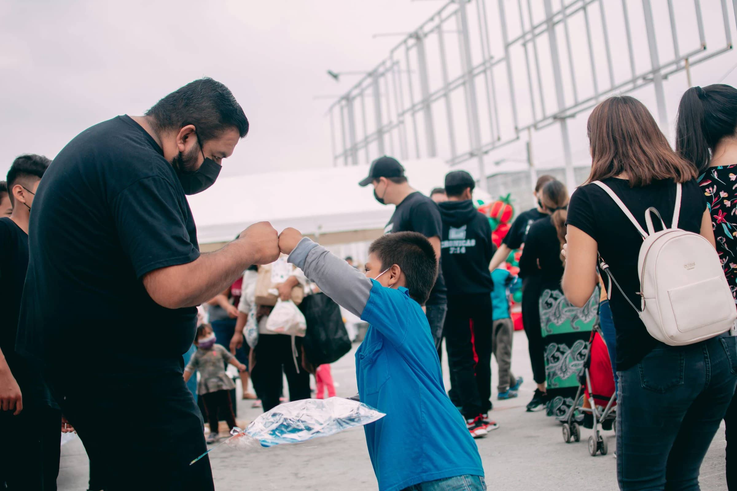 volunteer fist bumps kid