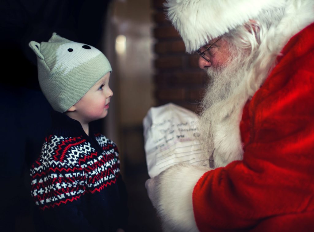 little boy giving Santa a wishlist