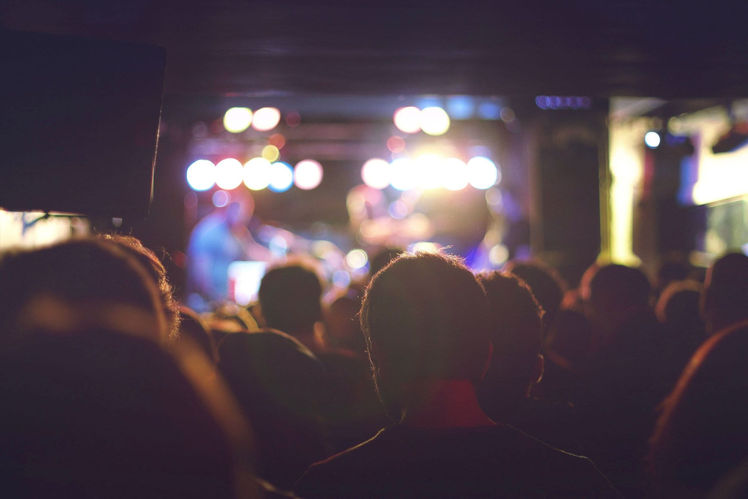 people looking at the stage at a concert