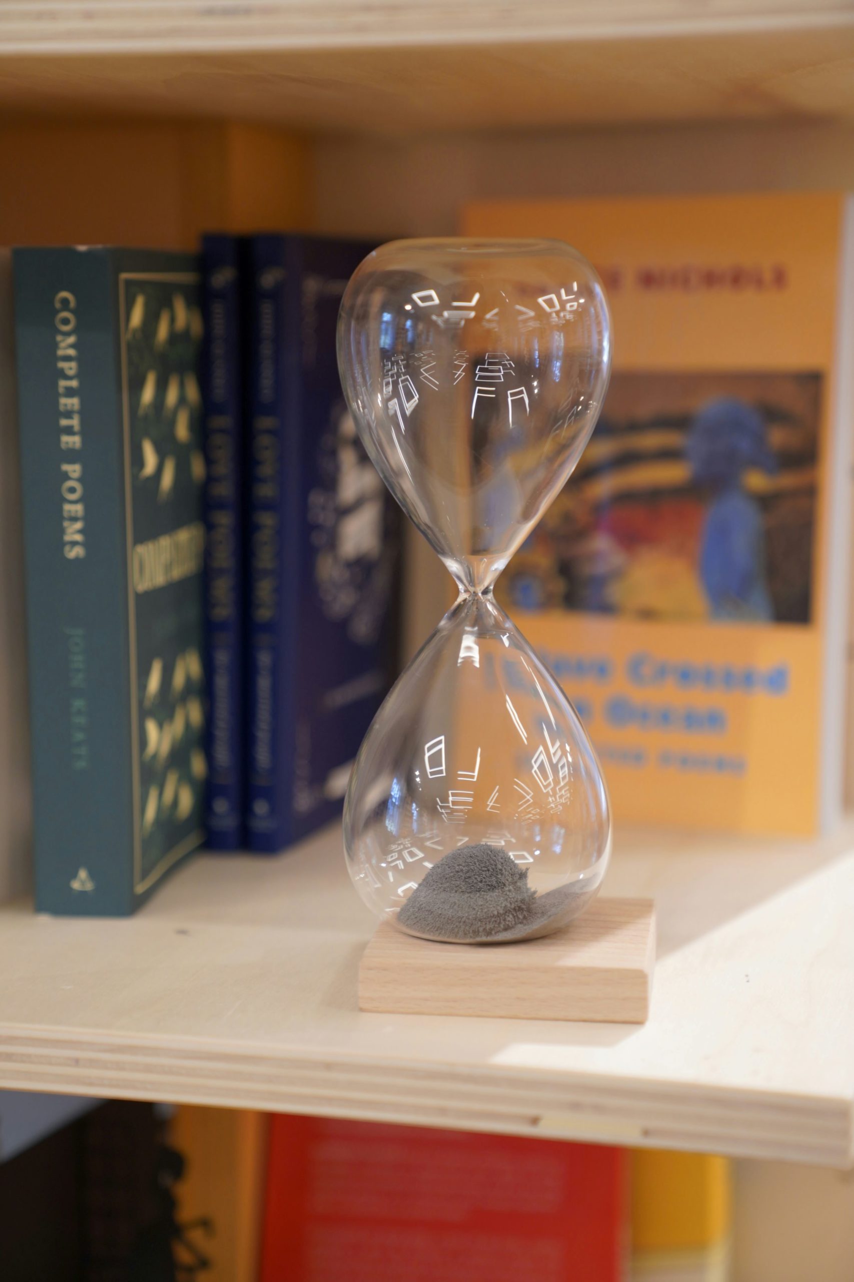hourglass on a book shelf