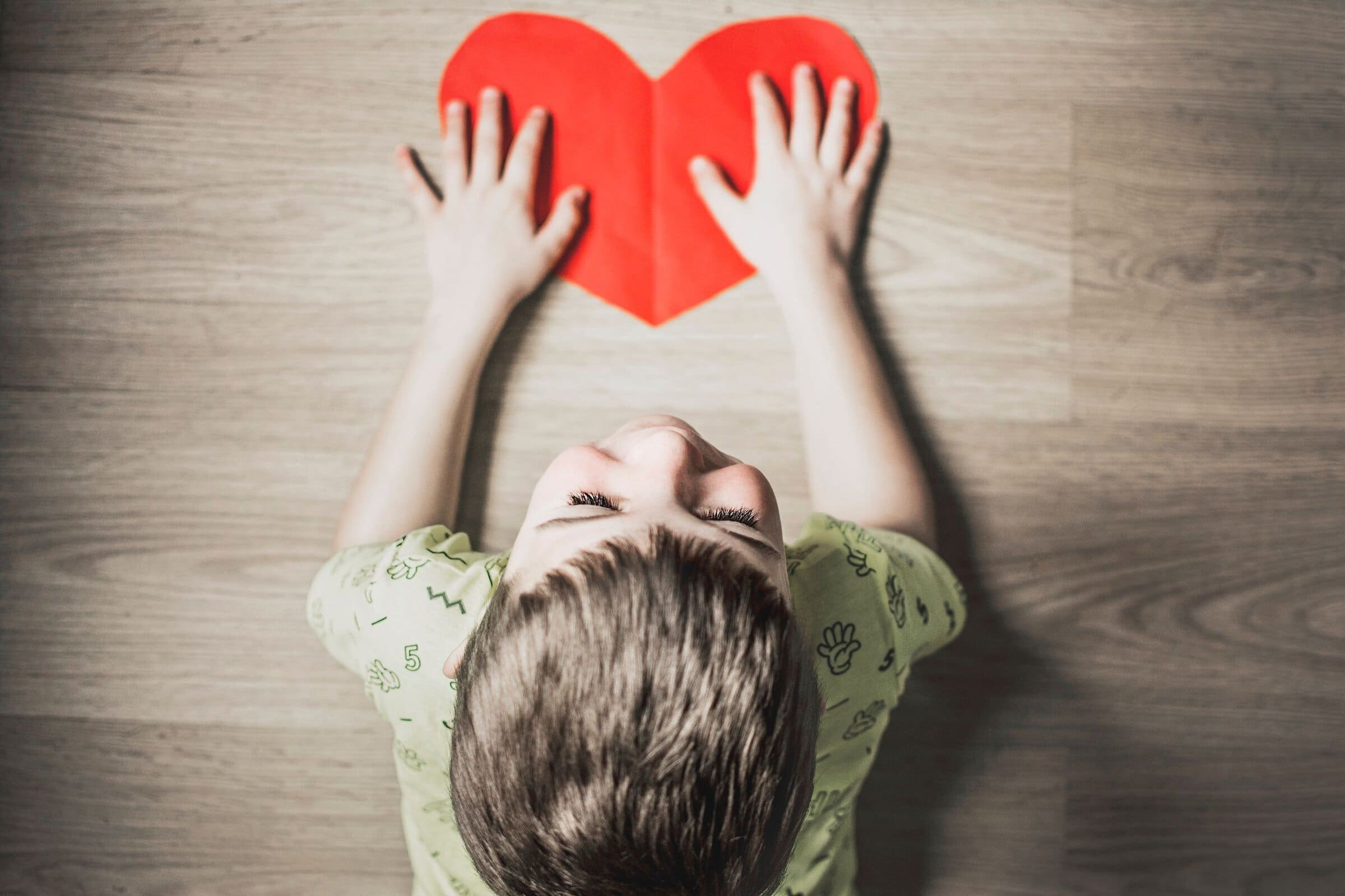 kid with red paper heart