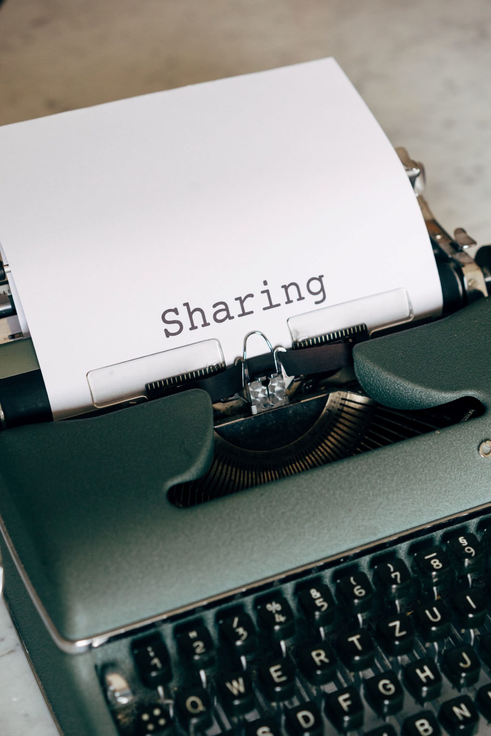 typewriter with paper that ways "sharing"