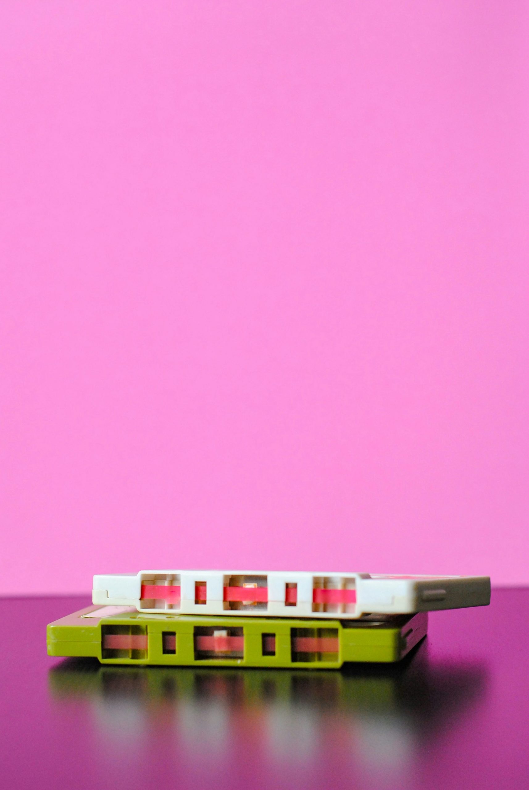 cassette tapes on bright pink background
