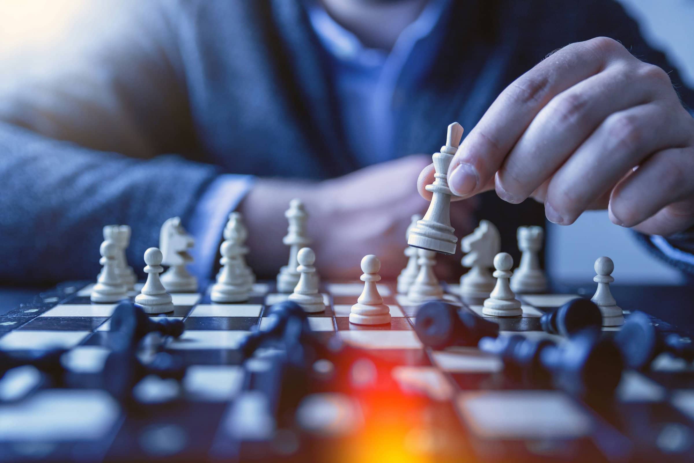 man seated behind chess board