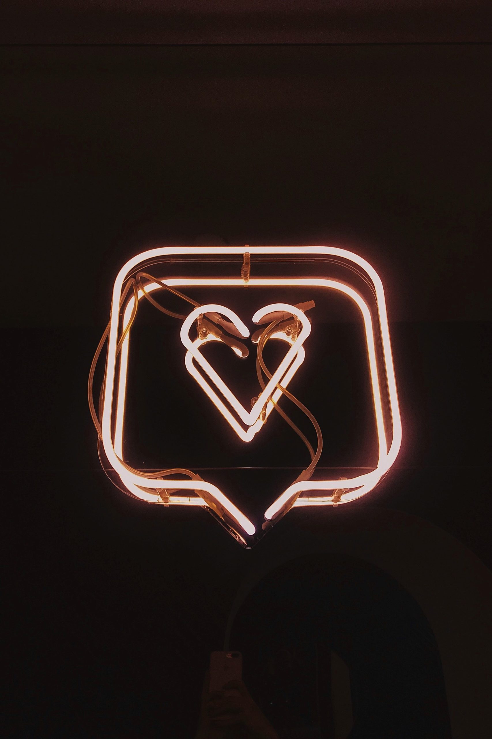 neon sign of a heart in a chat box