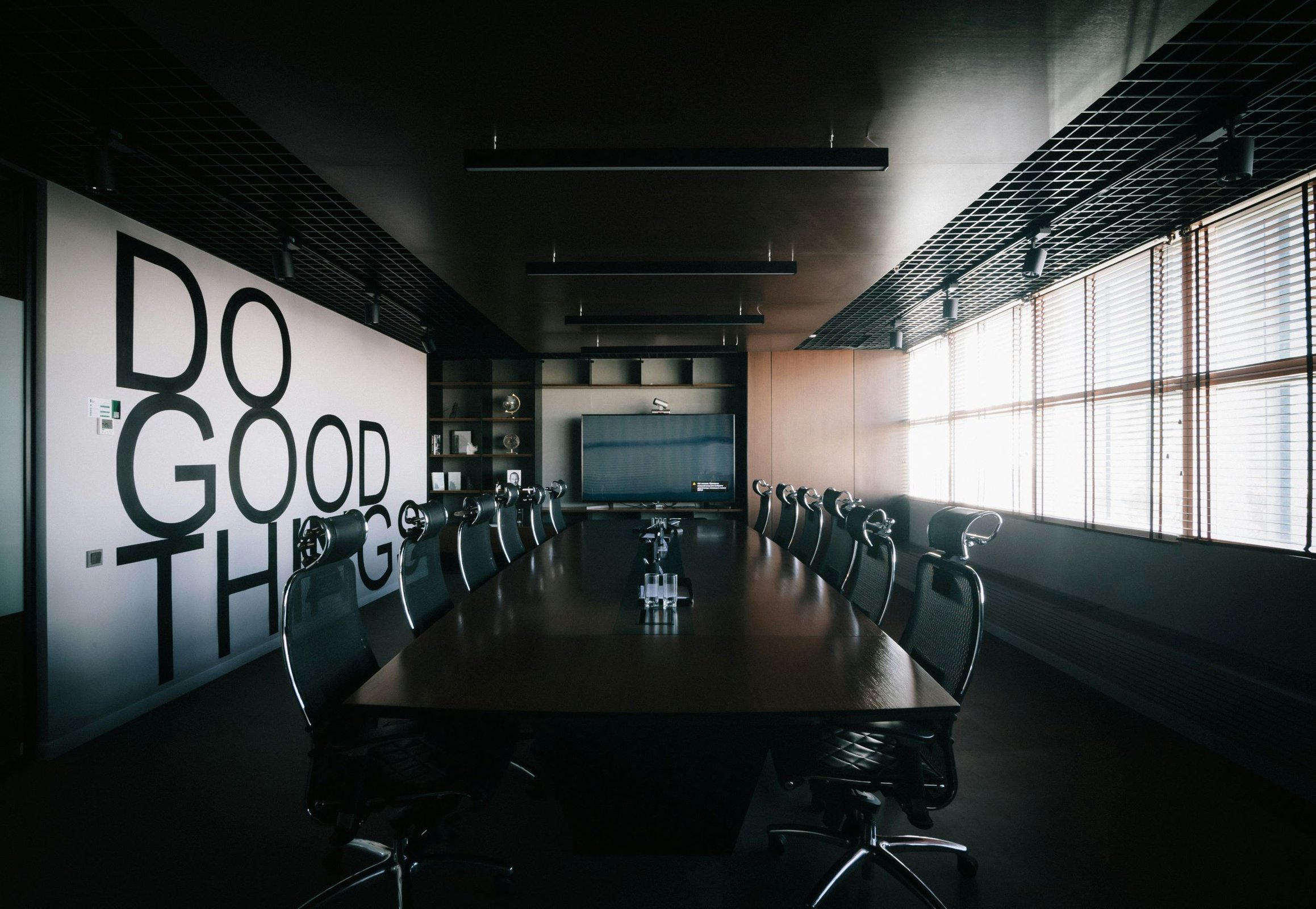 board room wiith accent wall that says "Do good things"