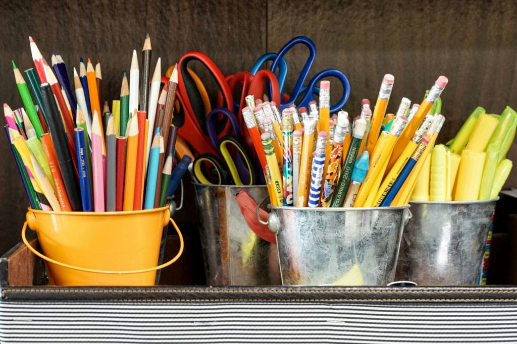 school supplies in cups and buckets