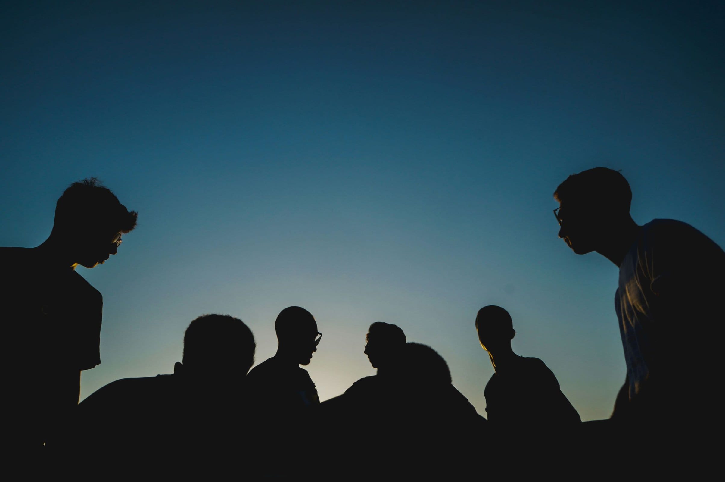group of people at dusk